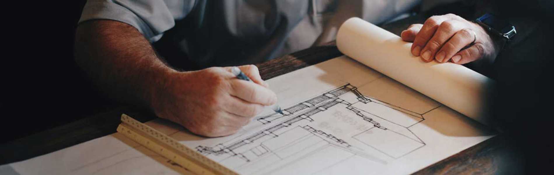 An engineer from Symmetry working on the blueprints for a sports field construction project