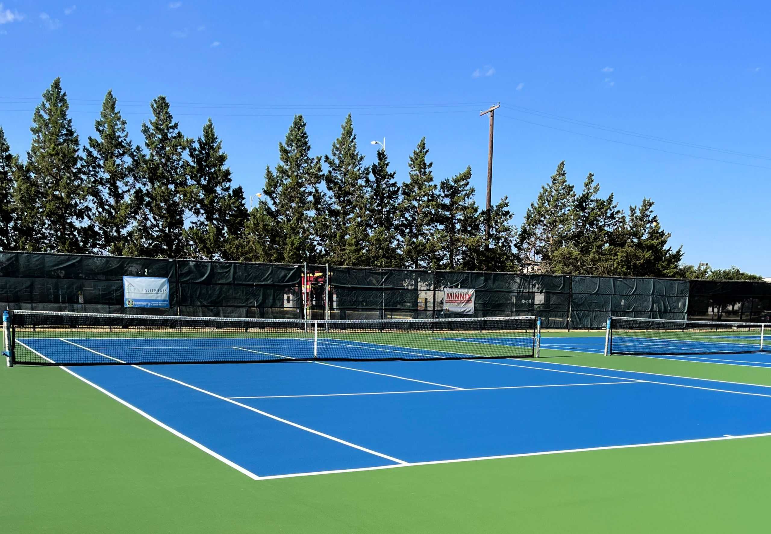 A tennis court installed by Symmetry Sports Construction, a artificial turf maintenance and sports construction company